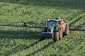 Agriculture - A farmer spraying fertilizer on his crops
