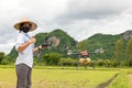 Agriculture farmer woman holds tablet to view a report on rice agriculture field, agriculture technology concept. Agriculture Royalty Free Stock Photo