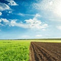 Agriculture green and black fields and sunset in blue sky with c Royalty Free Stock Photo