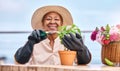 Agriculture, senior and black woman with plant in garden and happiness outdoor in nature for spring, flowers and growth