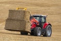 Agriculture - a tractor collecting bales of hay