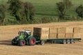 Agriculture - a tractor collecting bales of hay