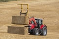 Agriculture - a tractor collecting bales of hay