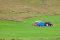 Tractor with plowes on an Iceland field