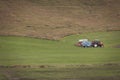 Tractor with plowes on an Iceland field