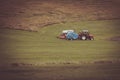 Tractor with plowes on an Iceland field