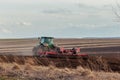 Agriculture,tractor preparing land with seedbed cultivator as part of pre seeding activities in early spring season of