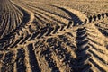 Agriculture tractor traces on farm field soil