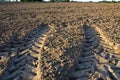 Agriculture tractor wheels traces on field soil Royalty Free Stock Photo