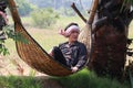 Agriculturist male sit relaxing on basketry crib with loincloth wrapped the head