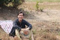 Agriculturist male use the loincloth on the floor for relax sitting and the hat in hand on nature