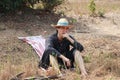 Agriculturist male use the loincloth on the floor for thoughtful sitting and wear hat on nature