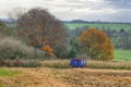 Agricutural field out of season in Winter - blue farming trailer