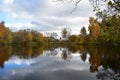 Agriturismo on the banks of a picturesque canal pond mixed forest deciduous and coniferous trees reflected in the water sky Royalty Free Stock Photo