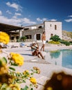a couple on vacation at Sicilian Agriturismo relaxing by the pool, bed and breakfast Sicily Italy