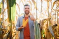 Agronomist checking corn if ready for harvest. Portrait of farmer. Royalty Free Stock Photo