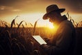 Agronomist farmer man using digital tablet computer in a young cornfield at sunset or sunrise Royalty Free Stock Photo
