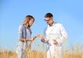 Agronomist with farmer in wheat field
