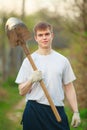 Agronomist handsome strong man with shovel on background of flo Royalty Free Stock Photo