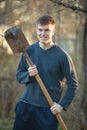 Agronomist handsome strong man with shovel on  background of flower beds Royalty Free Stock Photo