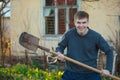 Agronomist handsome strong man with shovel on  background of flower beds Royalty Free Stock Photo