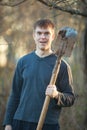 Agronomist handsome strong man with shovel on  background of flower beds Royalty Free Stock Photo