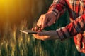 Agronomist using smart phone mobile app to analyze crop development Royalty Free Stock Photo