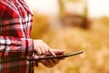 Agronomist using tablet computer in corn field during harvest Royalty Free Stock Photo