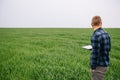 Agronomist with wheat in hands. Field of wheat on background Royalty Free Stock Photo