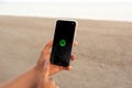 Aguadulce, Spain; October 2nd 2021: Woman hands using her mobile phone. Relaxing with music during a walk with the Spotify app