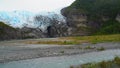 The Aguila Glacier with a flowing river of melting water close to Cape Horn