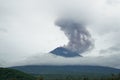 Agung volcano erupting cloud of smoke and ashes spreding
