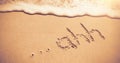 Ahh written on sand at beach with waves Royalty Free Stock Photo