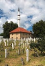 Ahmed-begova dÃÂ¾amija mosque surrounded by a cemetery. The mosque is located in Vitez, Bosnia and Herzegovina.