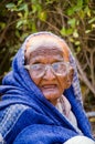 Close up of old aged poor lady bagging in front of mosque Royalty Free Stock Photo