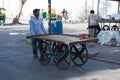 Ahmedabad / India / April 11, 2017: Indian man caring wheeled table