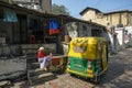 Woman sits next to an autorickshaw in Ahmedabad, Gujarat, India