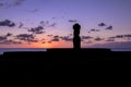 Ahu Tahai Moai Statue silhouette wearing topknot at sunset near Hanga Roa - Easter Island, Chile