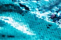 AI aqua blue trendy color of year 2021 sequin fabric texture. Shiny sparkling background. Clothing piece of glitter