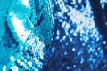 AI aqua blue trendy color of year 2021 sequin fabric texture. Shiny sparkling background. Clothing piece of glitter