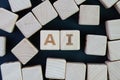 AI, Artificial Intelligence or machine learning in future world concept, straggle cube wooden blocks with some combine the word AI Royalty Free Stock Photo