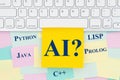 AI artificial intelligence programming languages type message on a sticky note on a computer keyboard