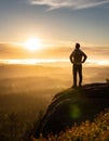 A man on the top of a hill feeling hope, strength, and motivation