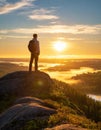 A man on the top of a hill feeling hope, strength, and motivation