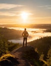 A man on the top of a hill feeling hope, strength, and motivation