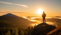 A man on the top of a hill feeling hope, strength, and motivation