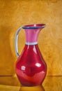 AI generated artwork of red-pink water jug against a saffron background