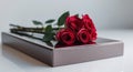 A box of chocolates with red roses on top. Royalty Free Stock Photo