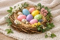 Colorful Easter Eggs In Natural Nest With Spring Flowers On Cozy Textile Background Royalty Free Stock Photo