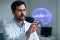 AI generated Chilean neuroscientist interacting with a violet-blue holographic brain pulse in a mind-interface laboratory, focused Royalty Free Stock Photo